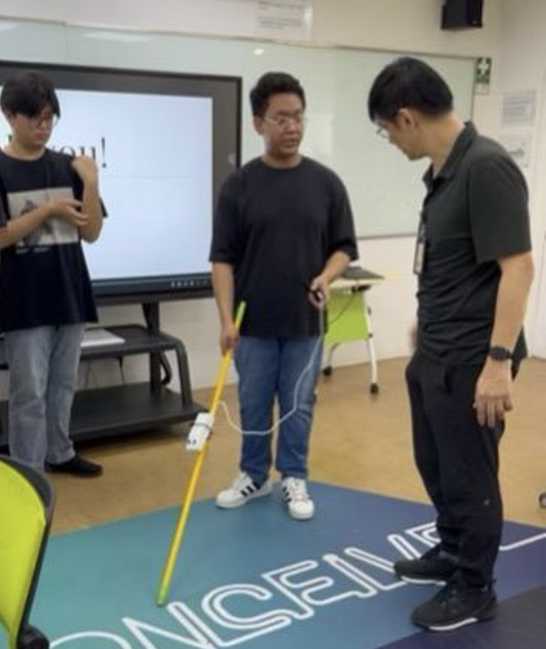 A visually impaired individual testing the SafeStride prototype in an urban setting, using a cane with the smart unit.
